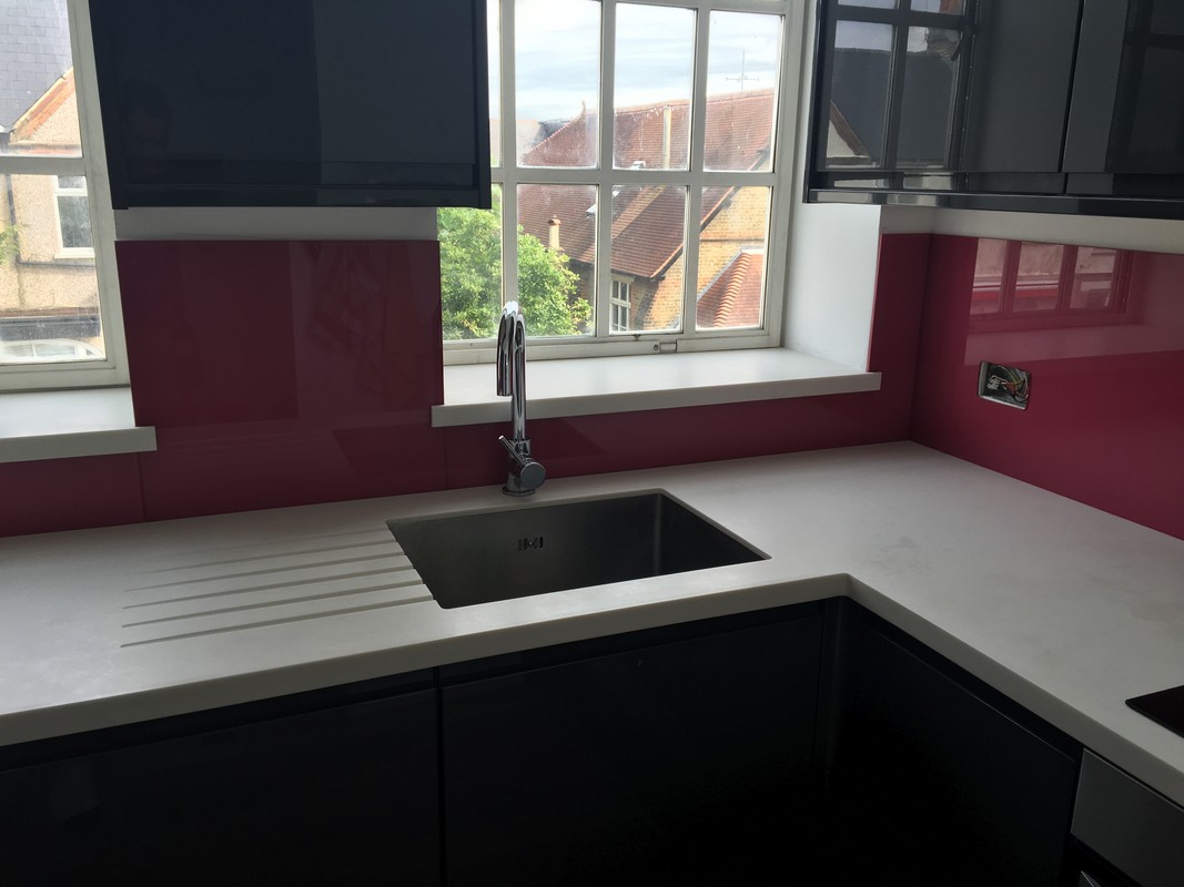 Deep plum coloured glass splashback in modern Witney kitchen